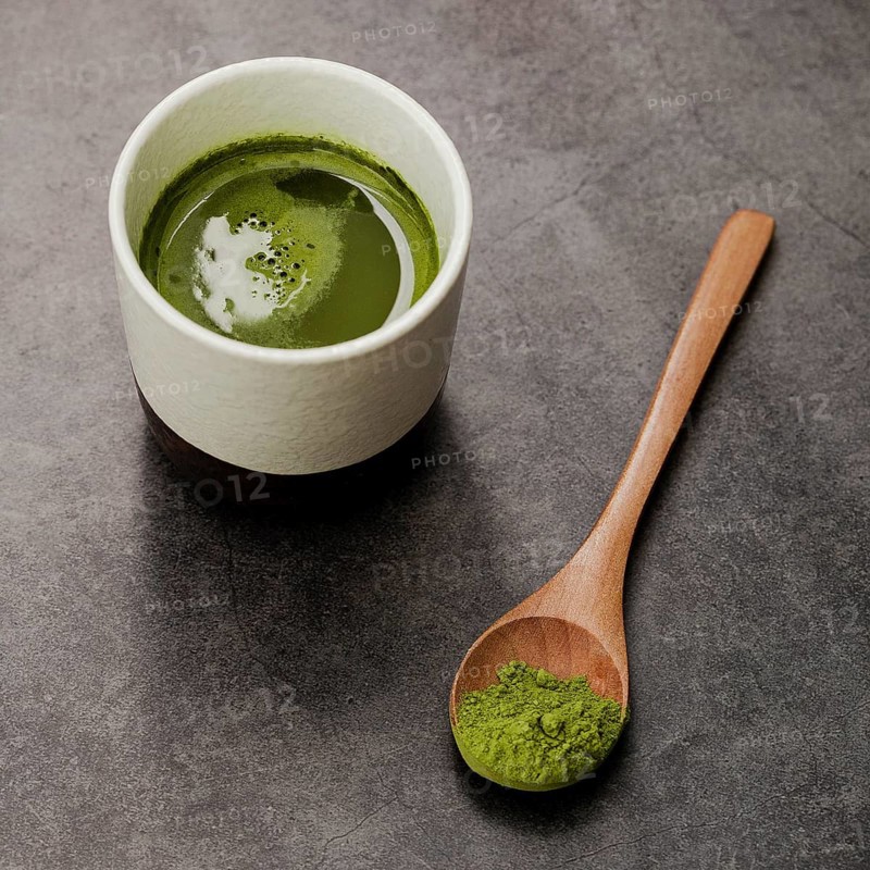 Close up matcha tea cup with wooden spoon