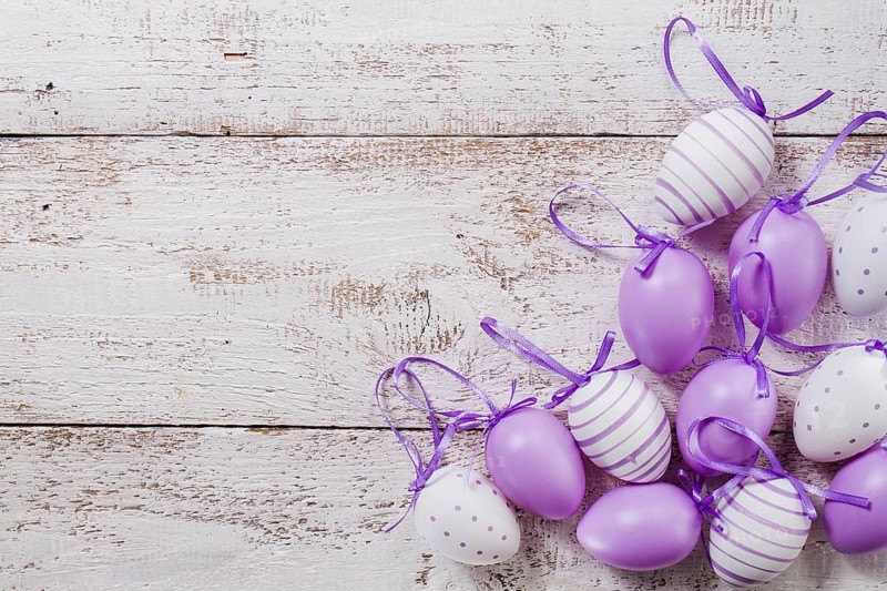 Wooden table with purple easter eggs