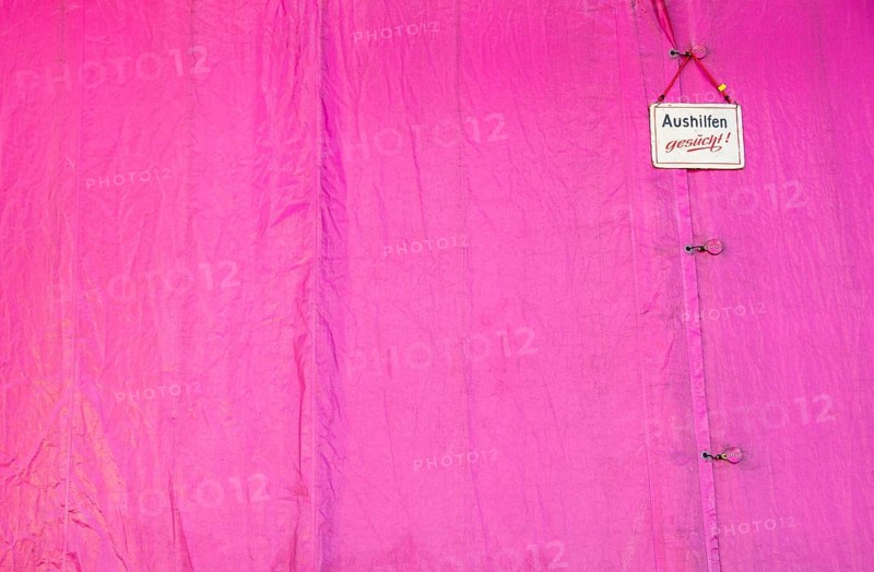 Sign on the tarpaulin at a funfair