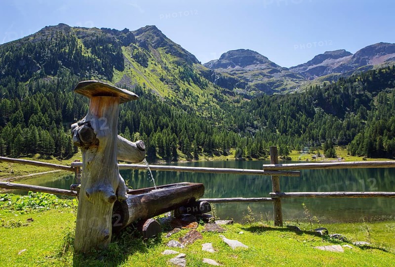 Wooden well on the mountain pasture with Duisitzkarsee