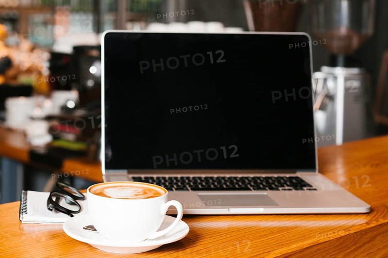 Frontview laptop coffee wooden surface