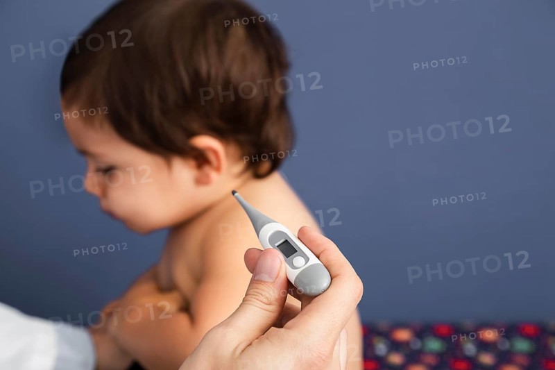 Close up doctor checking baby temperature