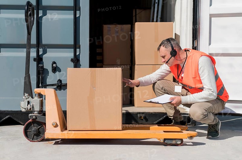 Full shot man with pallet truck
