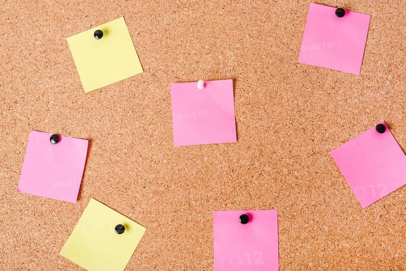 Close up corkboard with various note papers