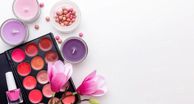 Top view make up products candles with copy space