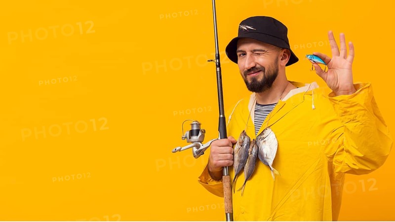 Fisherman holding fishing rod with bait