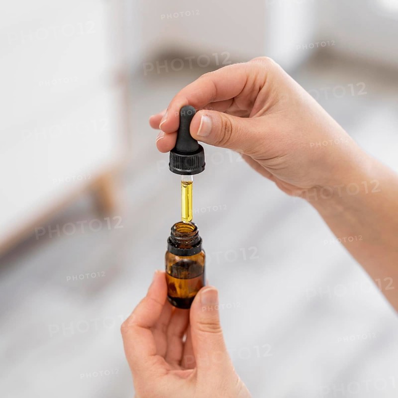 Close up hands holding serum