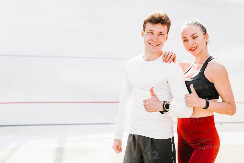 Medium shot sporty couple approving
