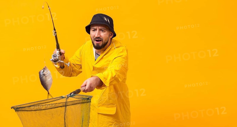 Front view fisherman holding fishing rod net with copy space