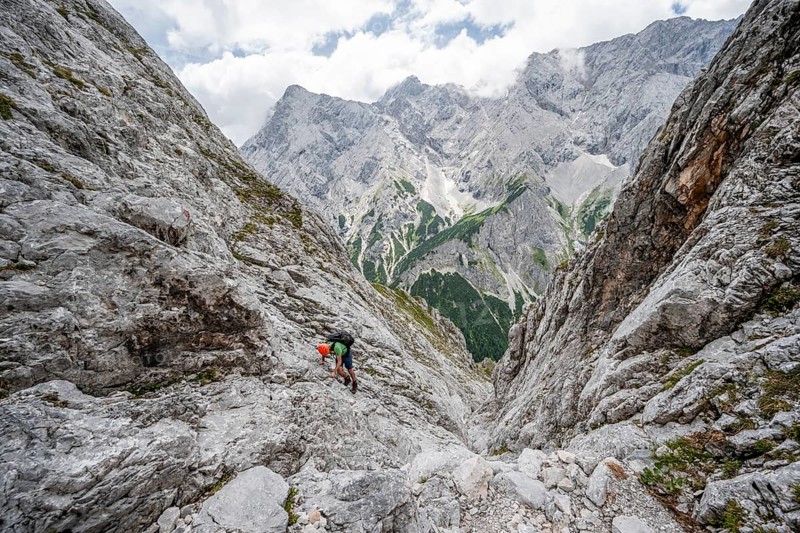 Mountaineer climbing in steep rocky terrain on the way to Waxenstein