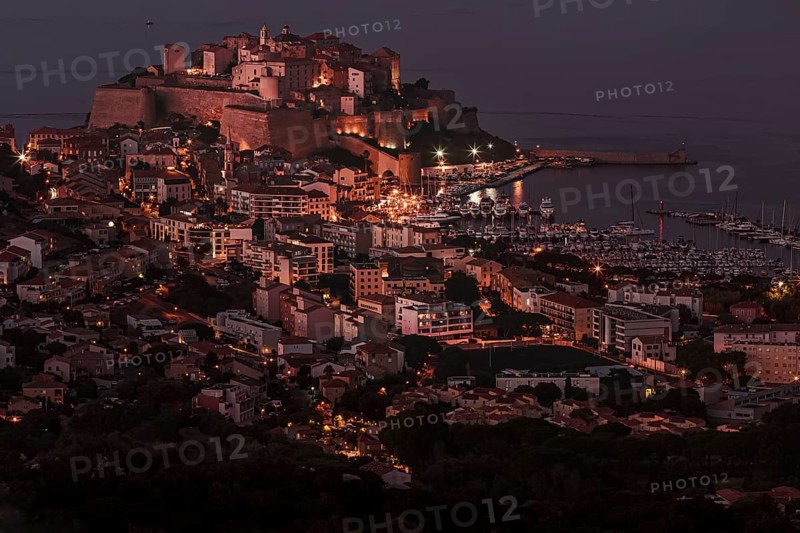 The illuminated town of Calvi at night on the northwest coast of Corsica France Europe