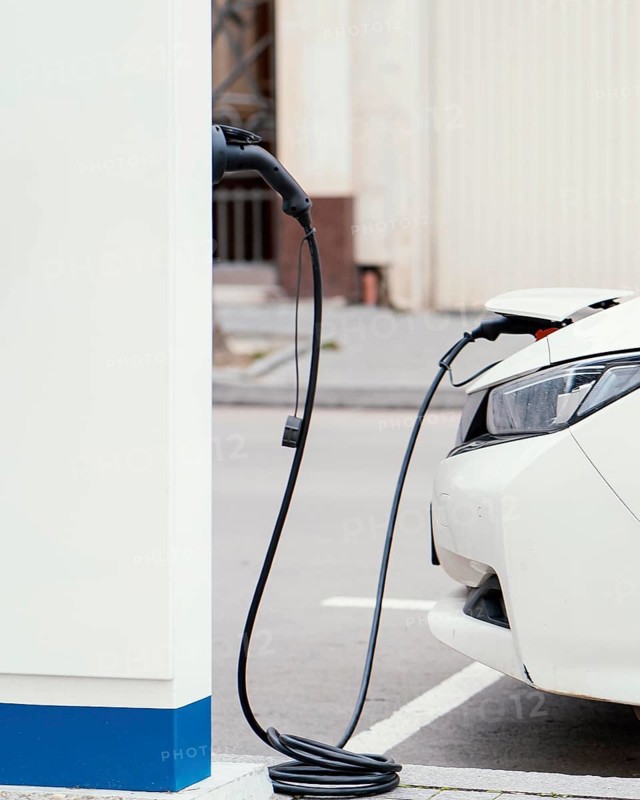 Side view car being charged electric vehicle charging station