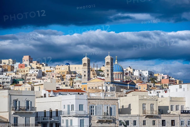 View of the town of Ermoupoli with pastel-coloured houses and the church of St Nicholas