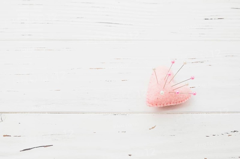 Sewing pins pink heart shape cushion