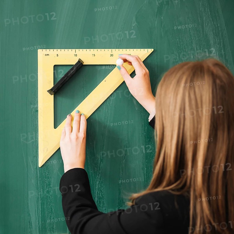 Woman drawing with triangular ruler blackboard