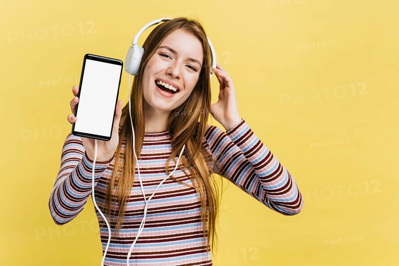 Happy woman listening music phone mock up