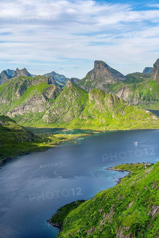 Mountain landscape with pointed mountain peaks and fjord Forsfjorden with village Vindstad