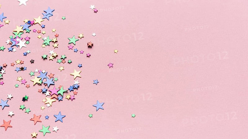 Confetti stars pink background with copy space