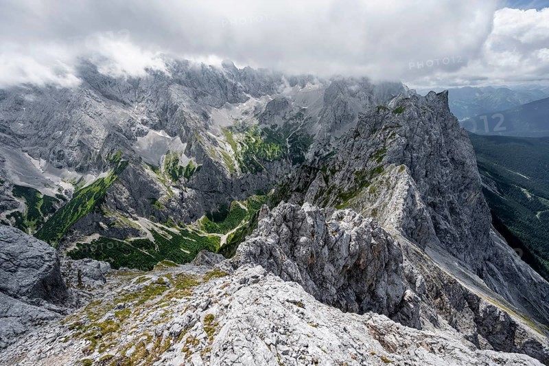 View from the summit of the Waxenstein over rocky and narrow ridge of the Waxenstein ridge to Hoellental with Jubilaeumsgrat