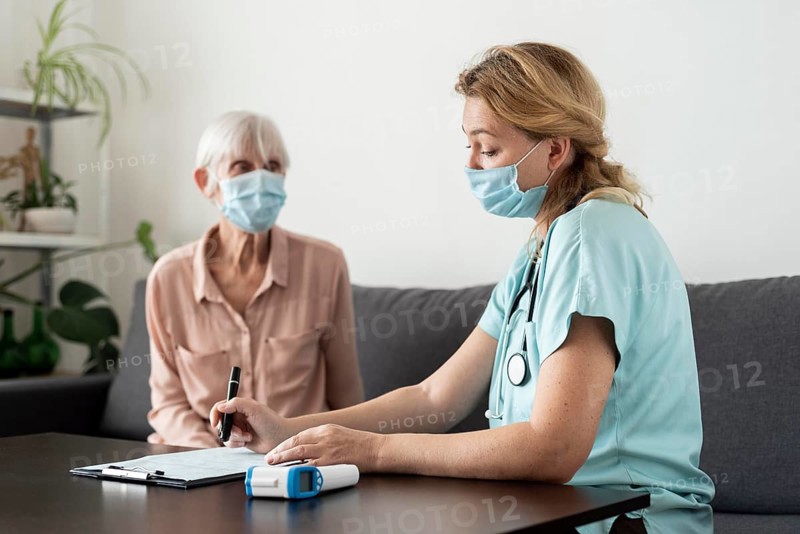 Nurse senior woman during check up nursing home