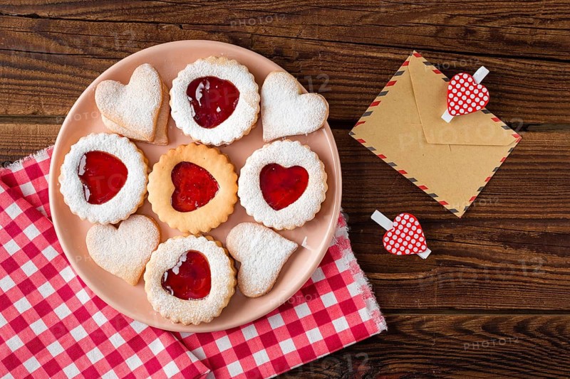Top view heart shaped cookies plate with jam