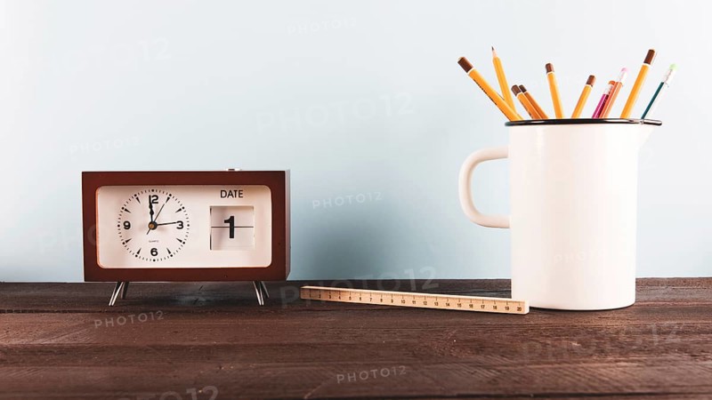 Ruler pencils near clock