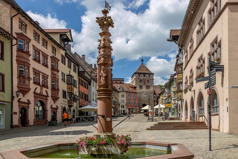 Apostle's Fountain and Old Town with old traditional houses with oriels in Black Forest style and Black Gate