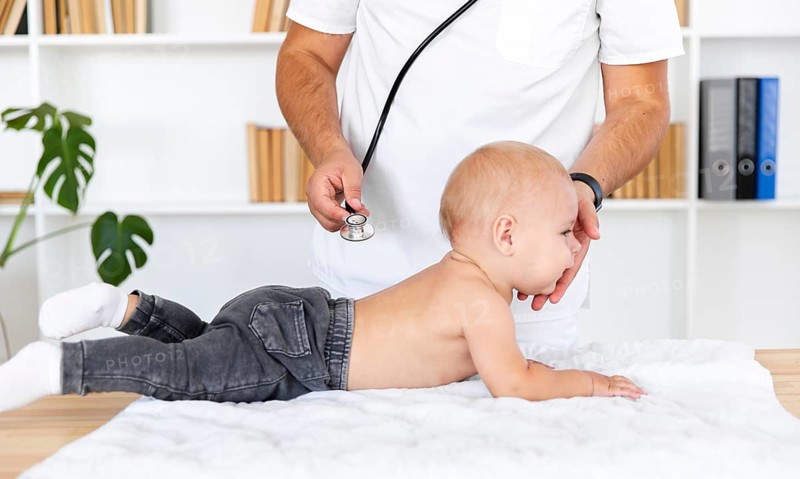 Doctor hands listening baby patient with stethoscope