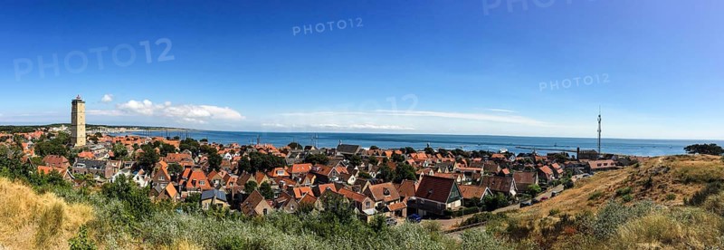 Panorama of the small town of West on Terschelling with the landmark Brandaris and view of the Wadden Sea