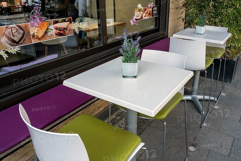 White tables and chairs in front of bistro