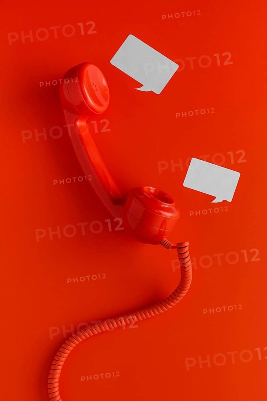 Top view telephone receiver with cord chat bubbles