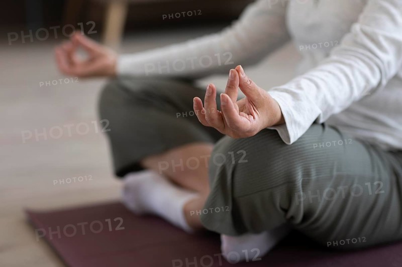 Close up person meditating home