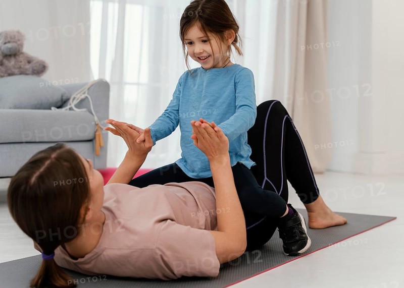 Mother training with smiley child