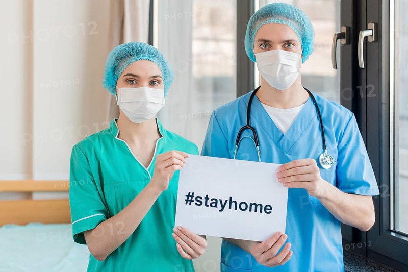 Nurses with stay home message