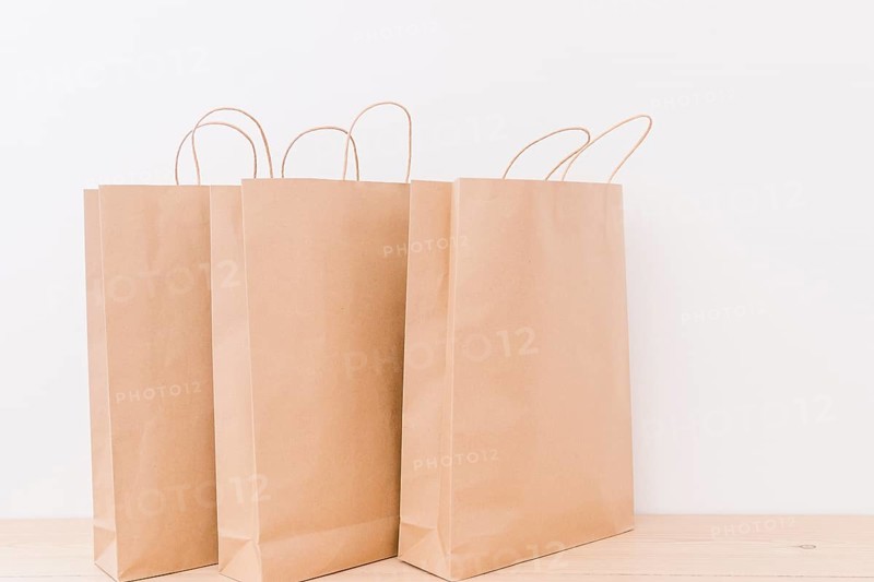 Close up paper shopping bags wooden desk