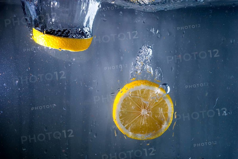 Two slices lemon falling water