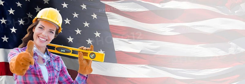 Female contractor wearing blank yellow hardhat and gloves over waving american flag background banner