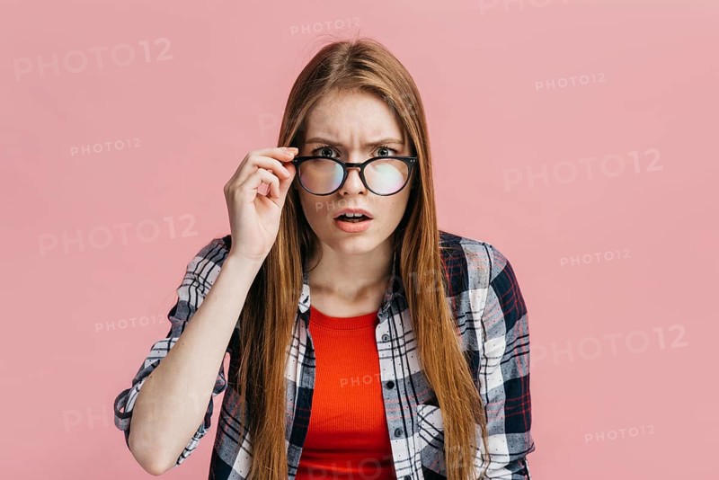 Woman with glasses looking suspicious