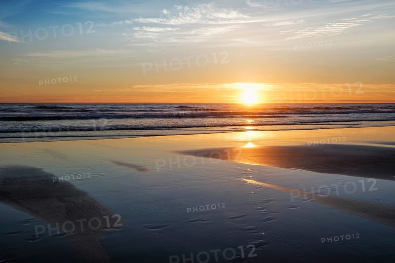 Atlantic ocean sunset with surging waves at Fonte da Telha beach