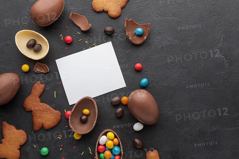 Top view chocolate easter eggs with colorful candy copy space