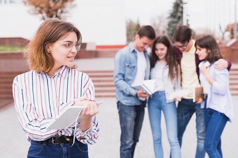 Woman glasses standing holding notebook hands