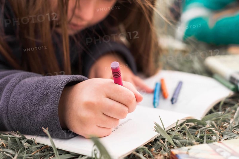 Anonymous girl drawing grass