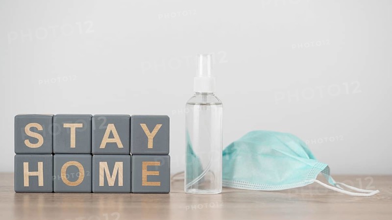 Wooden cubes with stay home hand sanitizer medical mask