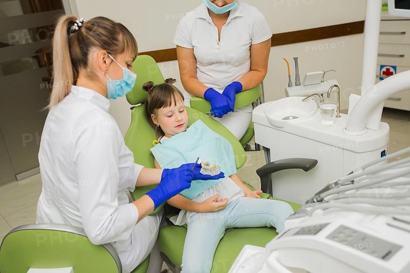 Dentist girl looking dentures