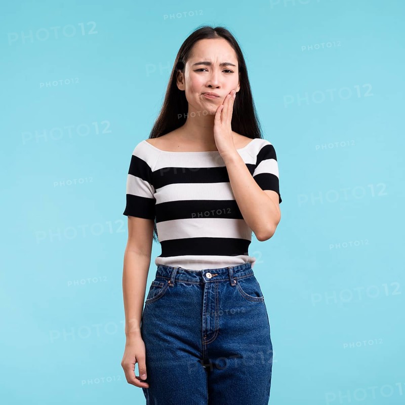 Young woman with tooth pain
