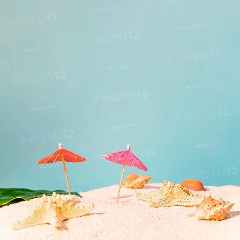 Beach with red sun umbrellas starfishes