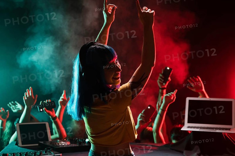 Smiley female dj mixing club