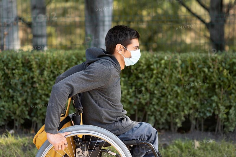 Medium shot disabled man wearing mask
