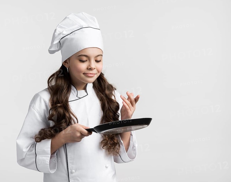 Front view curly hair young girl holding cooking pan