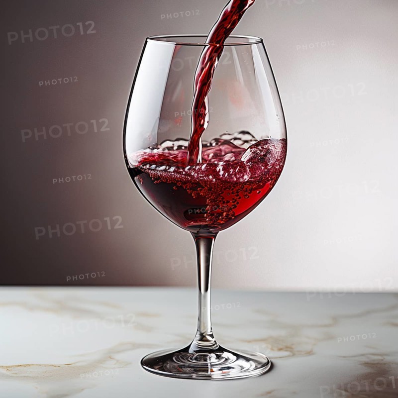 Wine is poured into elegant wine glasses